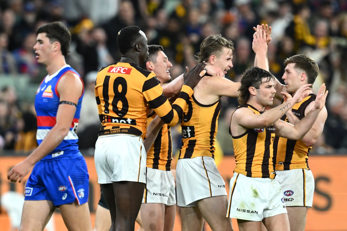 Calsher Dear celebrates scoring a goal with teammates during the AFL elimination final match between the Western Bulldogs and the Hawthorn Hawks at the MCG on Friday.