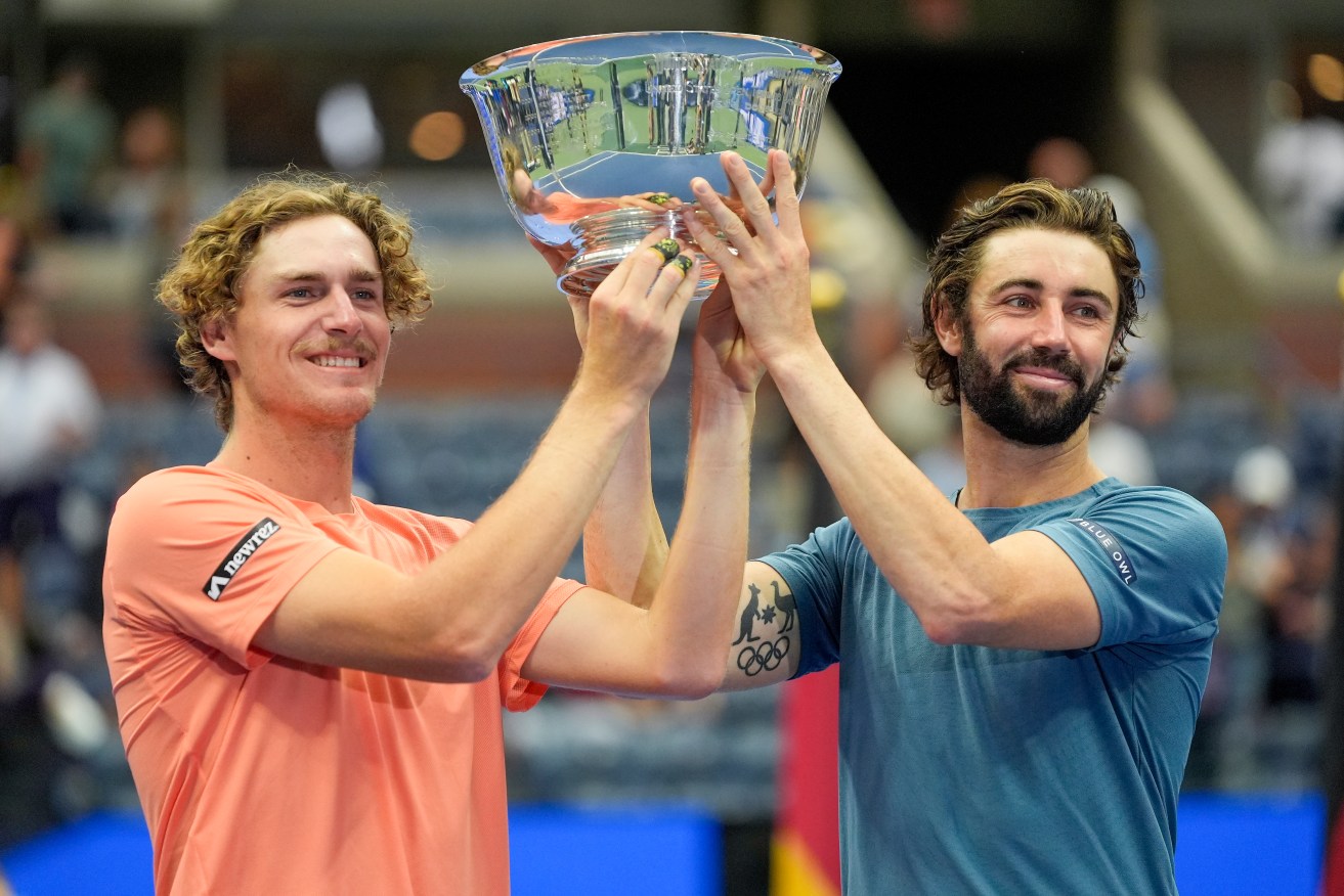 Max Purcell and Jordan Thompson hold up the championship trophy.