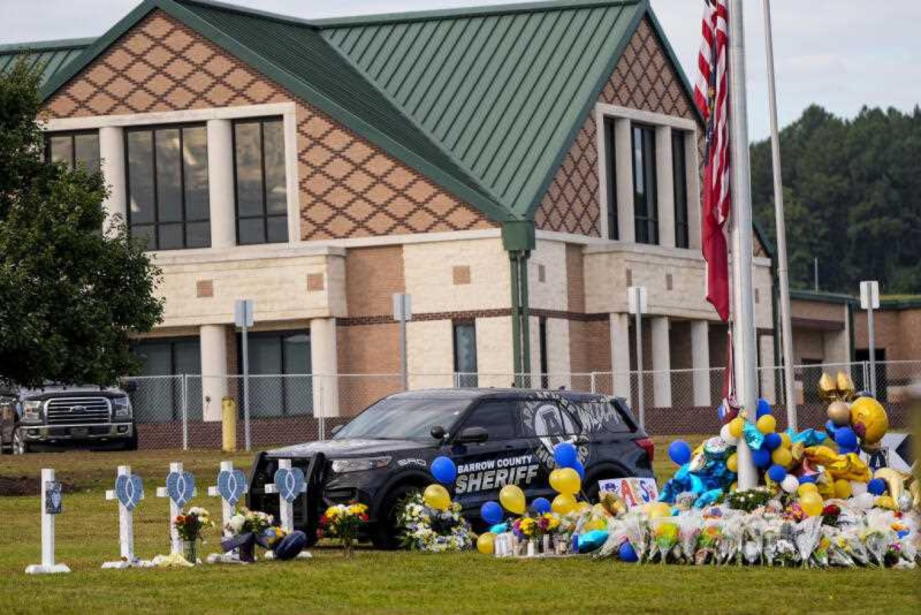 A 14-year-old was charged over the killing of two students and two teachers at a high school.