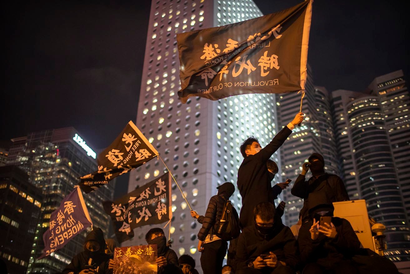 A man who wore a T-shirt with a protest slogan has been jailed for 14 months in Hong Kong.