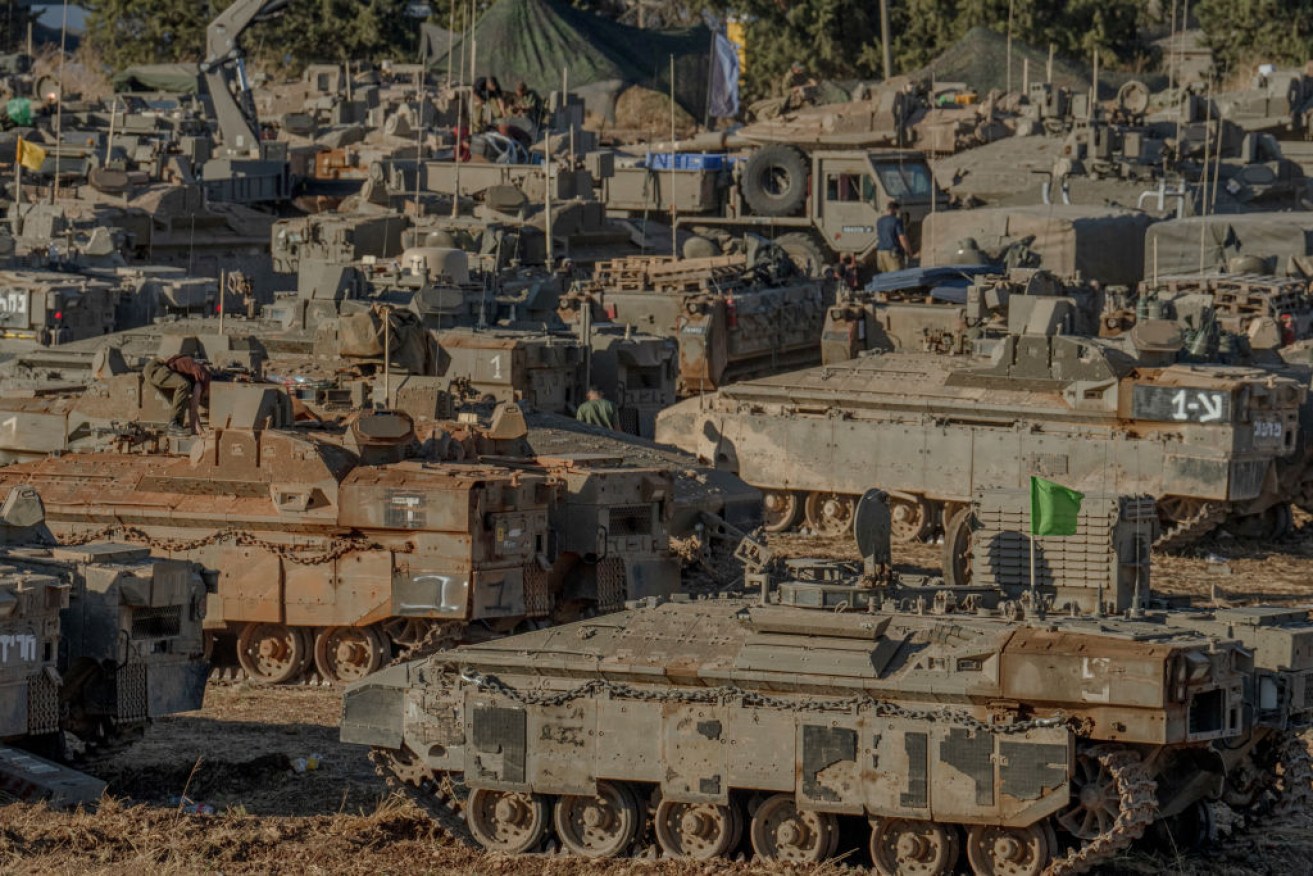 Israeli tanks and APCs gather at the Israeli - Lebanese border.