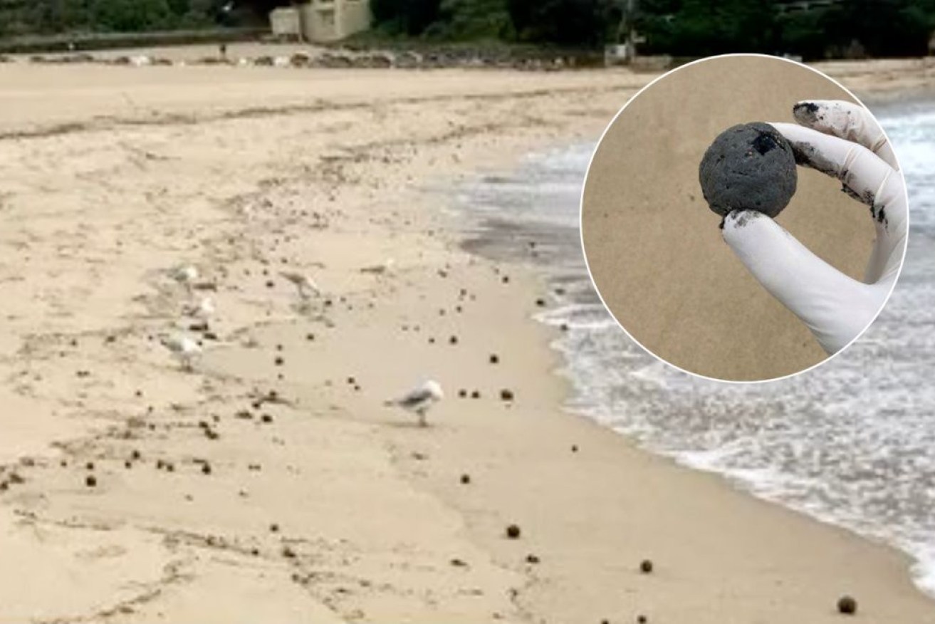 Coogee Beach has been closed off as environmental officers collected samples of a dark material.
