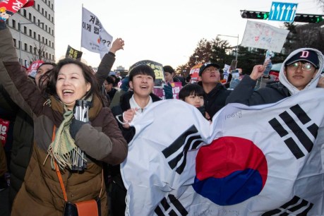 Mass party, defiance, after South Korea impeaches