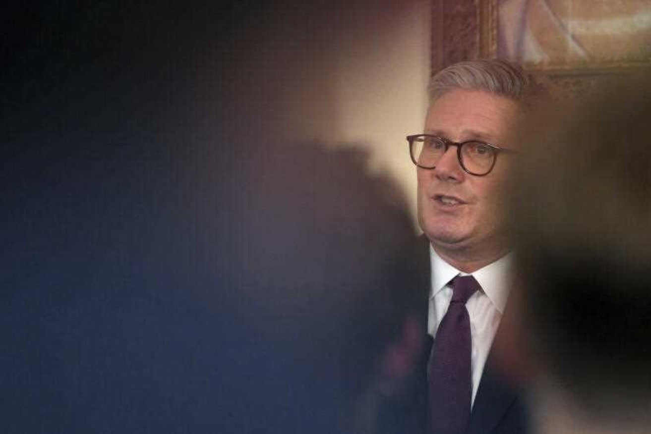 The UK will boost military spending while cutting its aid budget, Prime Minister Keir Starmer says.