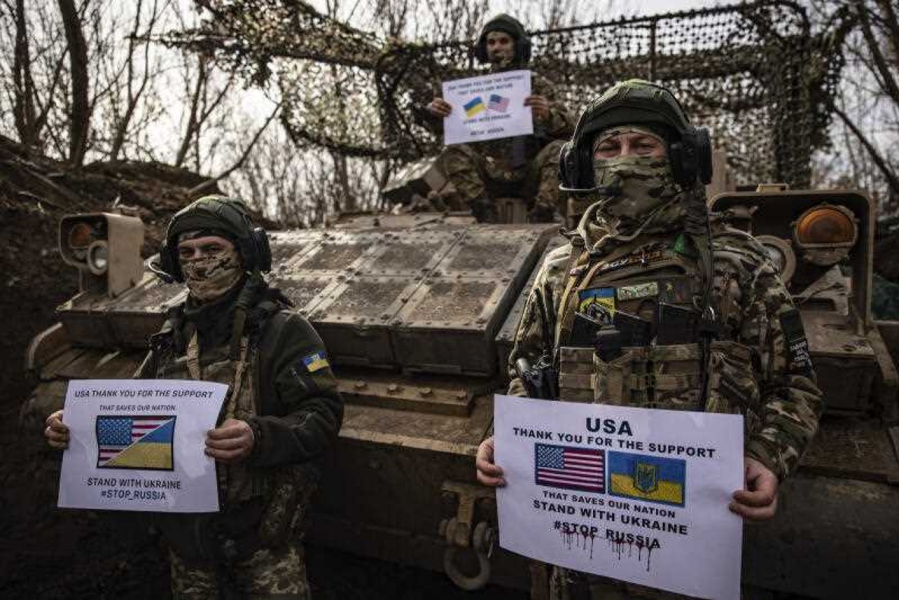 Ukrainian soldiers in the Donetsk region hold posters thanking the US for its military support.
