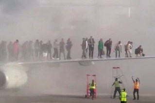 Passengers on wing as plane catches fire 