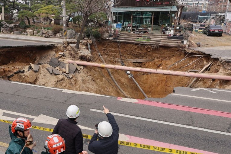 Dashcam shows sinkhole swallowing motorcyclist