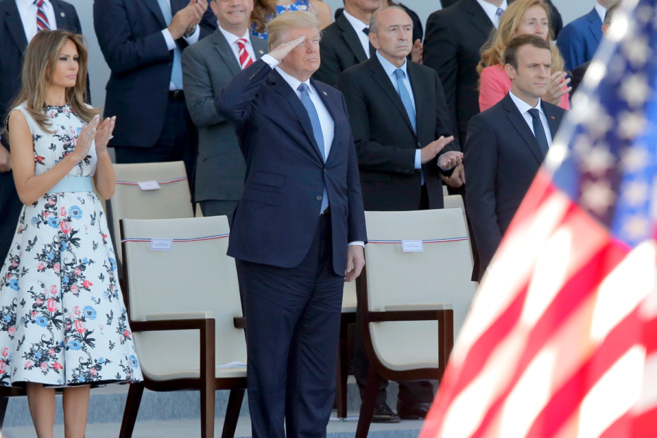 Trump with wife Melania and French President Emmanuel Macron at the 2017 Bastille Day parade.