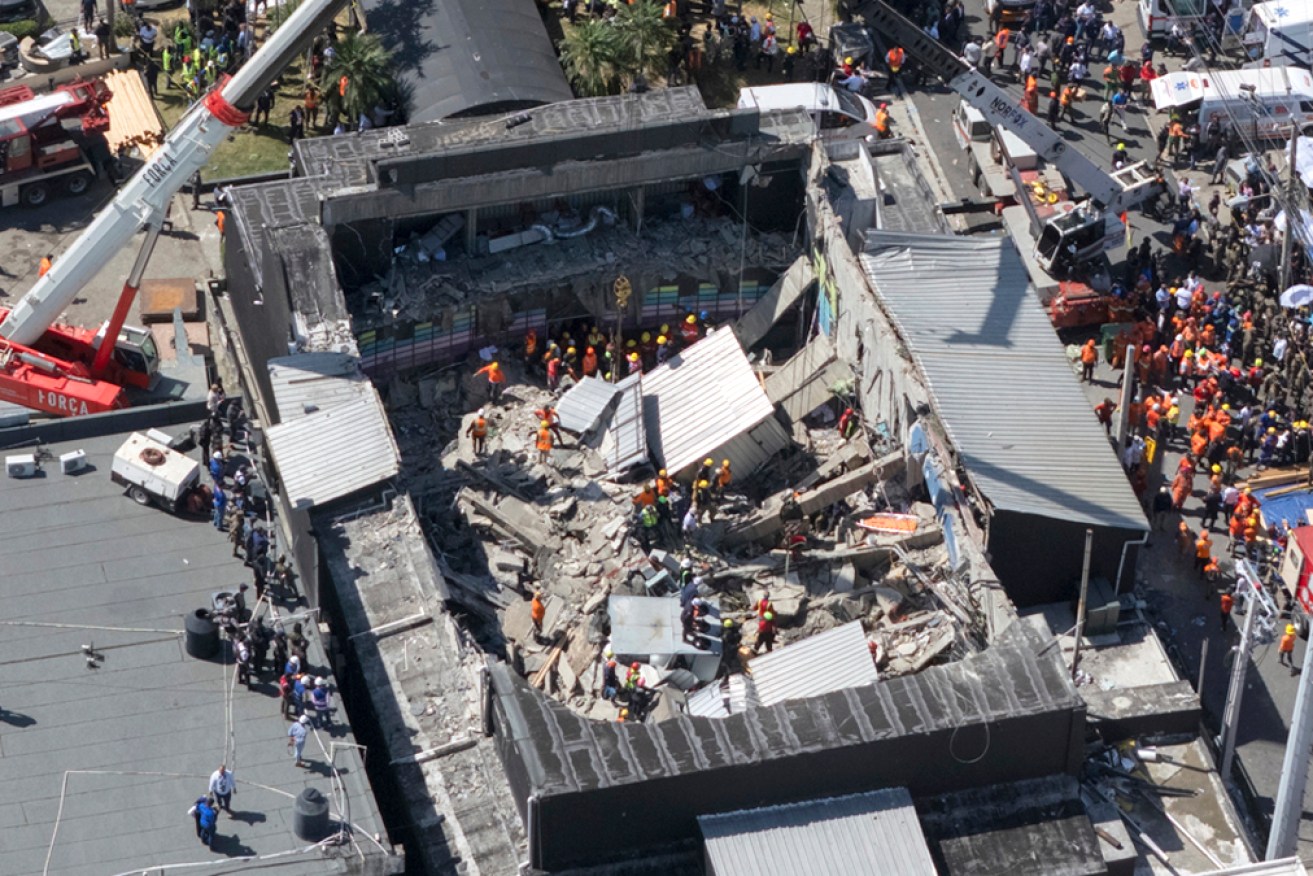 Rescue workers search for survivors at the Jet Set nightclub after its roof collapsed during a concert.
