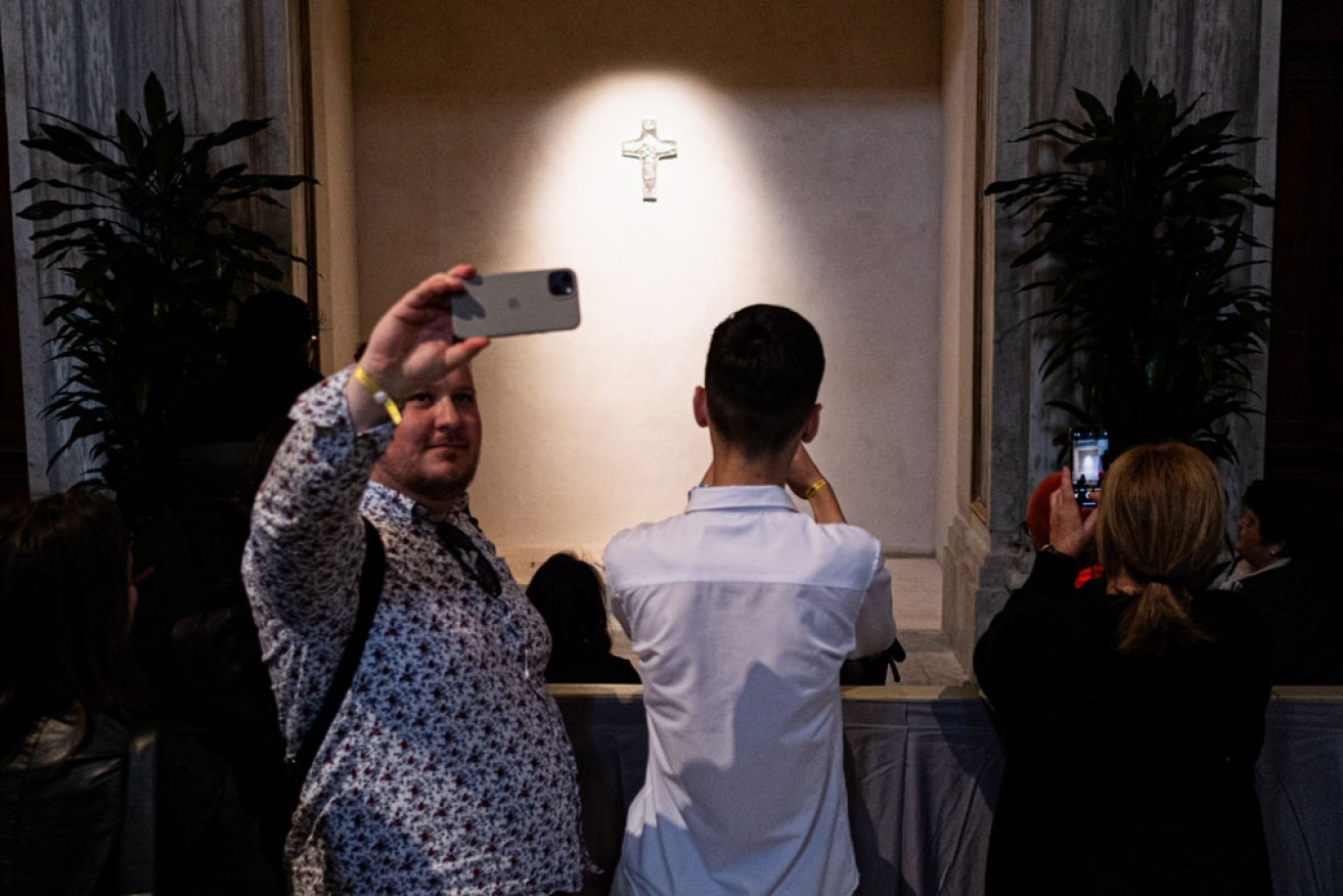 Many visitors take the opportunity to take a selfie at the tomb of Pope Francis. <i>Photo: Sipa USA</i>