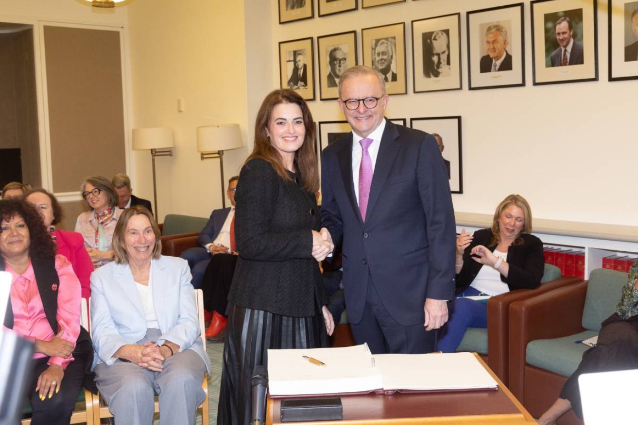 The Prime Minister Anthony Albanese welcomes the new member for Dickson Ali France to the caucus room on Friday.