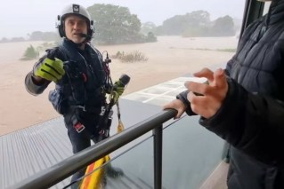 Rooftop rescues, dozens stranded in record floods