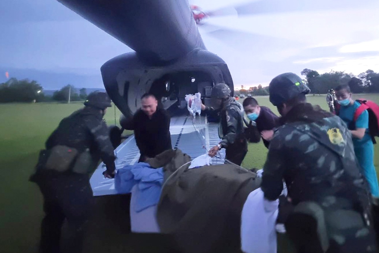This photo released by the Royal Thai Army, shows an injured Thai soldier being flown to hospital.