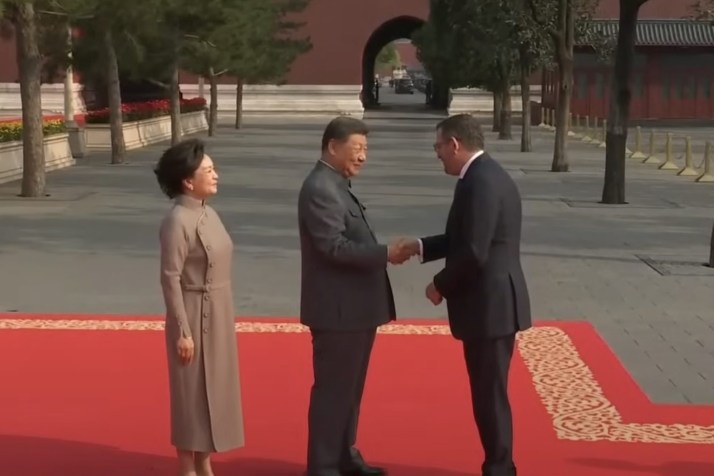 Andrews slammed over photo with dictators