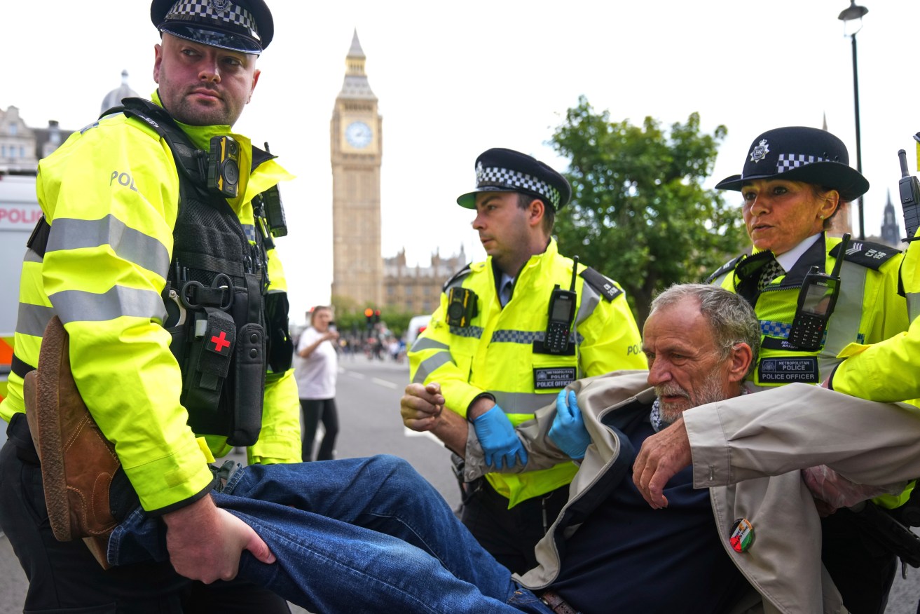 Police officers carry a protester during a protest to support Palestine Action in London, Saturday, Sept. 6, 2025.(AP Photo/Joanna Chan)