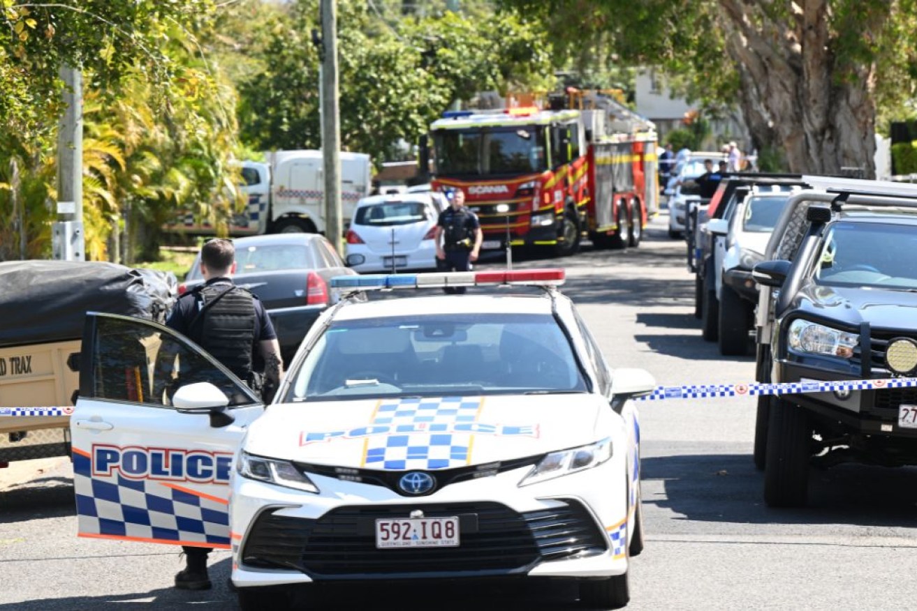 A man has been shot in a Brisbane backyard by police who were responding to a house fire.