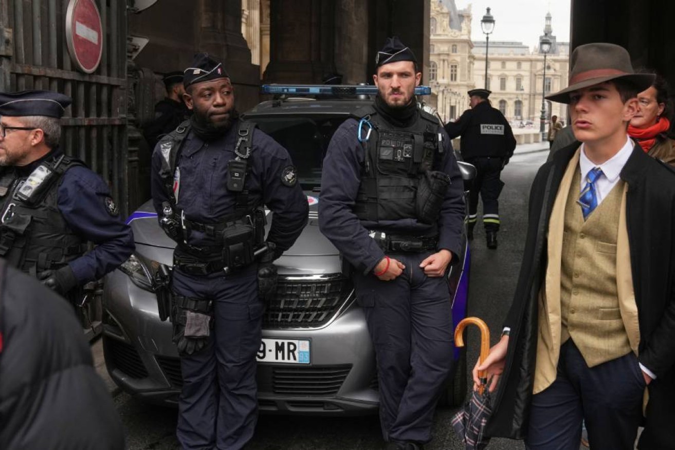 Pedro Elias Garzon Delvaux walked past police outside the Louvre after the Paris museum was robbed.