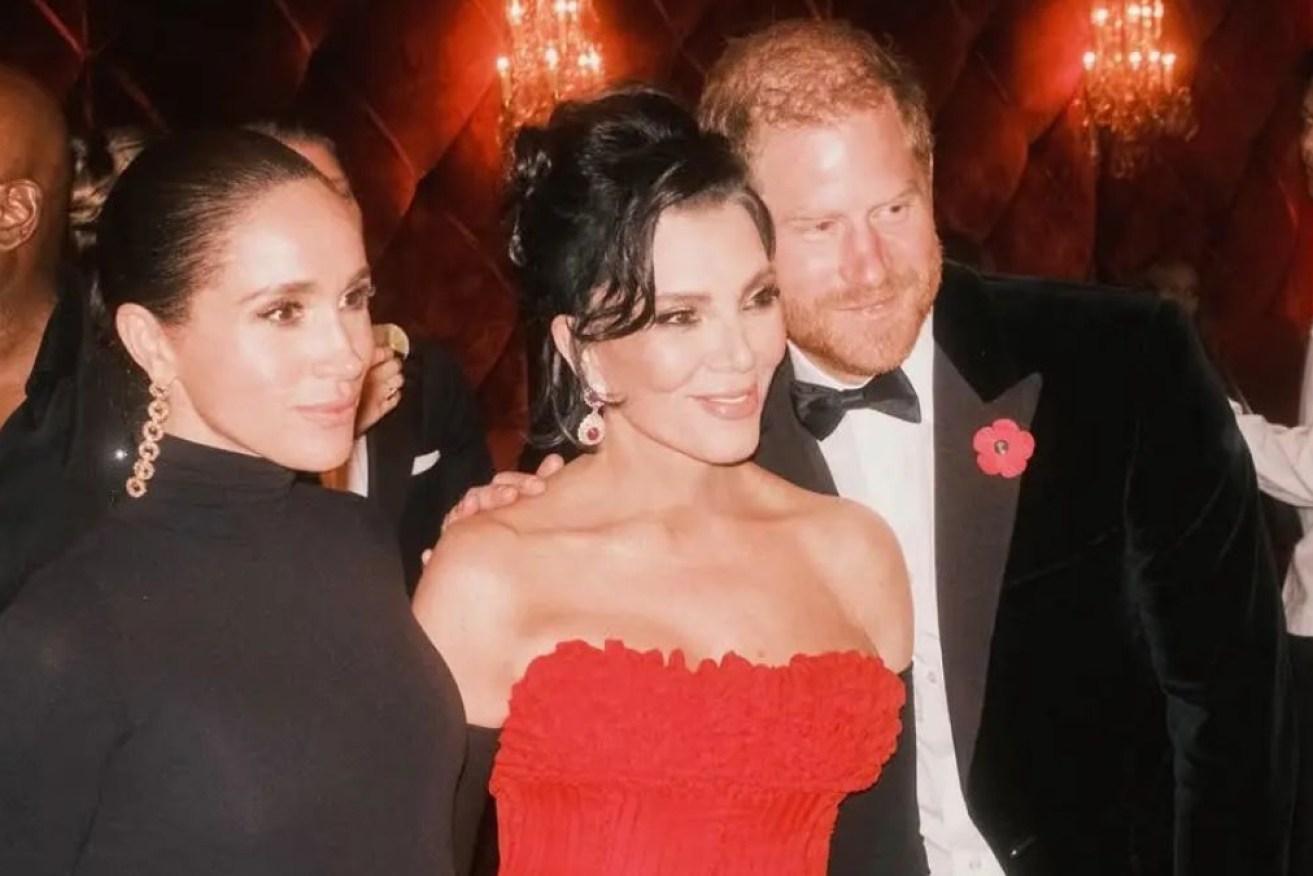 Harry and Meghan pose with Kris Jenner at her 70th birthday party.