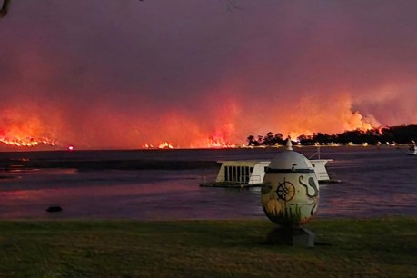 Aerial help sought as fire threatens coastal town