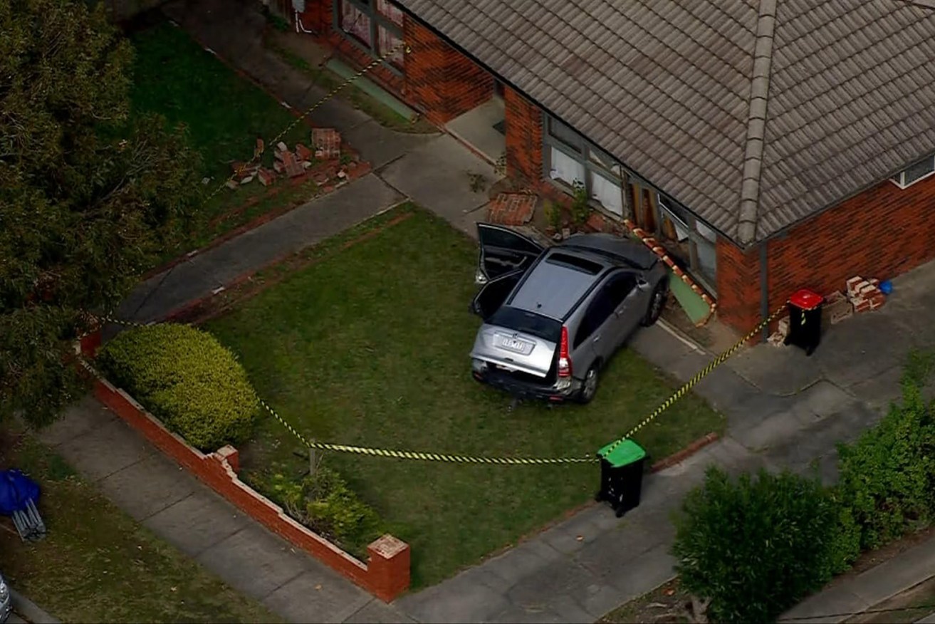The man crashed his car into a property and allegedly stabbed the female occupant.