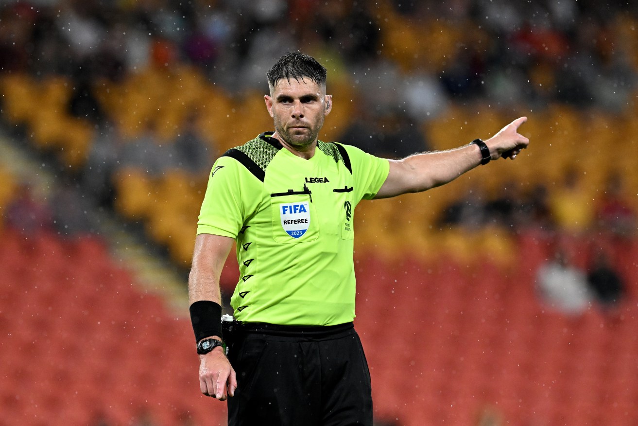 Australian World Cup official Shaun Evans has landed in hot water over a hand gesture.