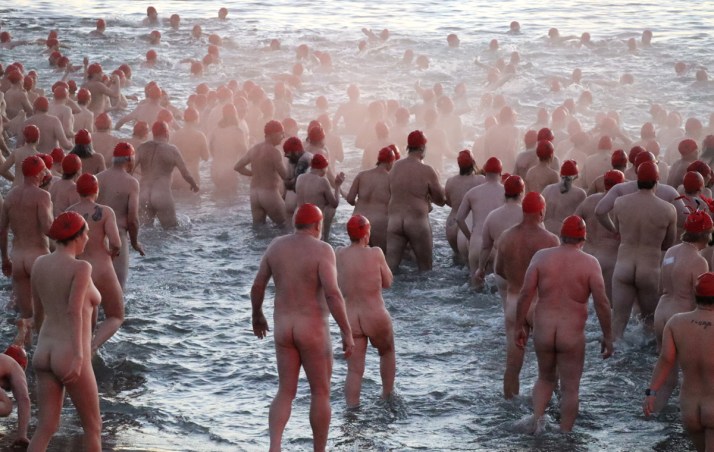 Thousands grin and bare it for solstice swim