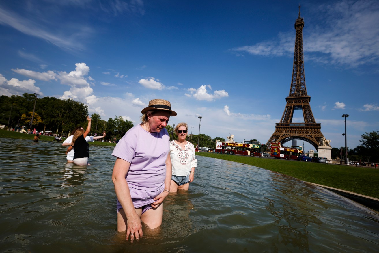 Cooling off in the Trocadero Fountain by the Eiffel Tower, in Paris.