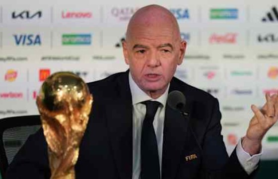 A sports administrator holds a trophy at a press conference