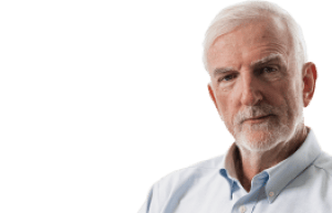 A retired man photographed against a plain background