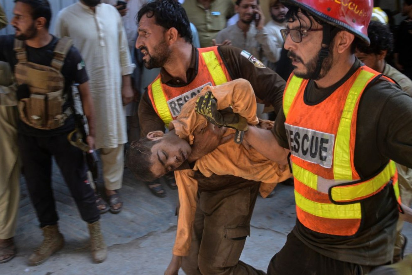Rescuers carried bloodied children to waiting ambulances after a school roof collapsed in Pakistan.