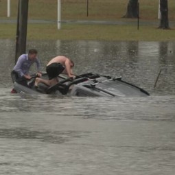 Man rescued as record rain slams south-east Qld