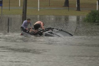 Man rescued as record rain slams south-east Qld