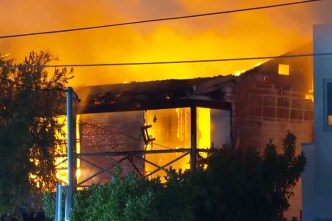 Manhunt after woman rescued from inferno