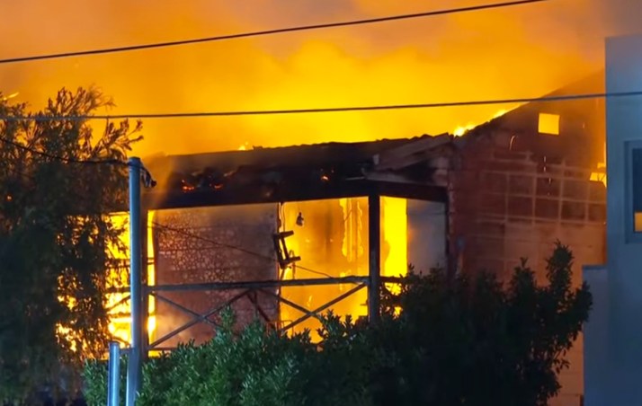 Manhunt after woman rescued from inferno